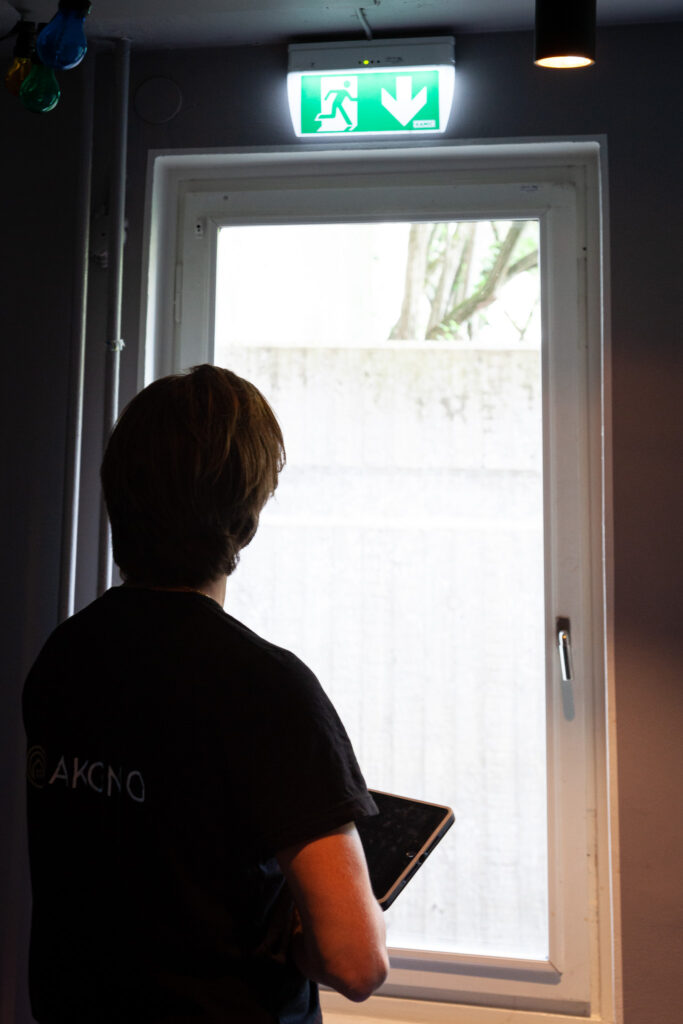 Tekniker från Akono kontrollerar en utgång i ett flerbostadshus