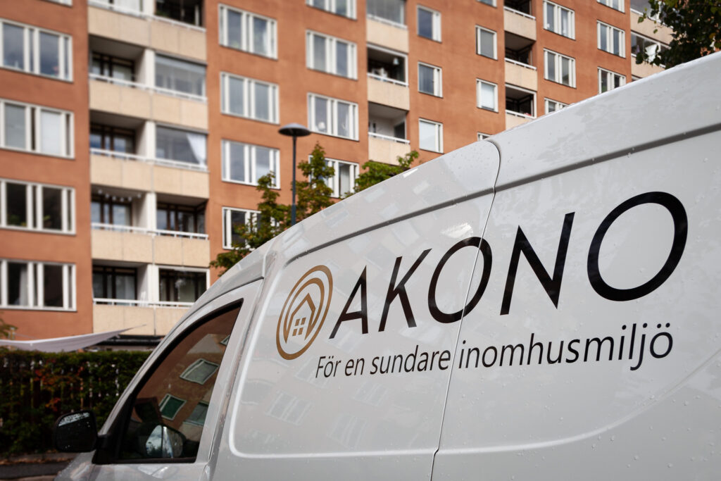 Akonos servicebil framför ett flerbostadshus
