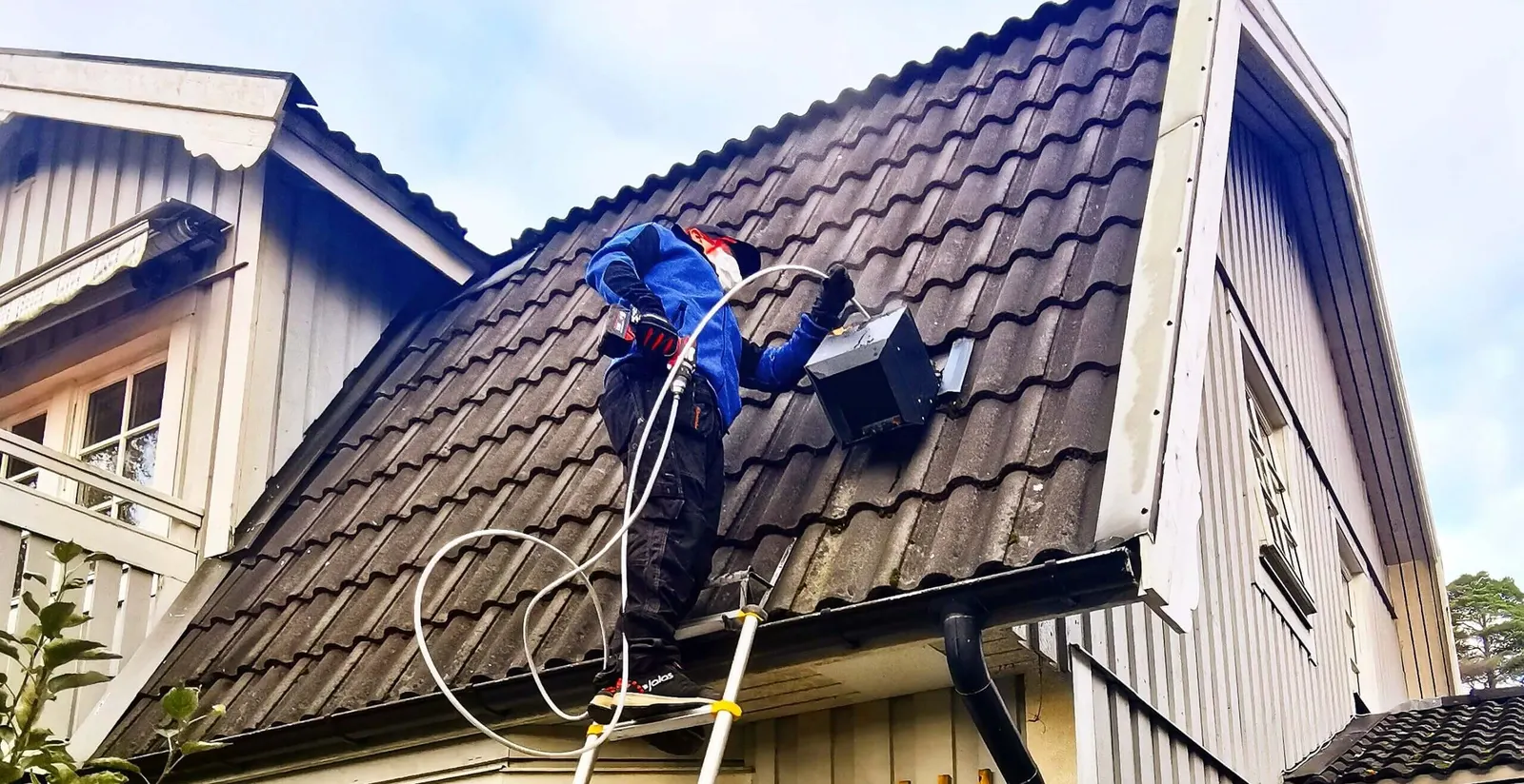 Tekniker från Akono rensar en ventilationskanal från takfläkten i Vällingby